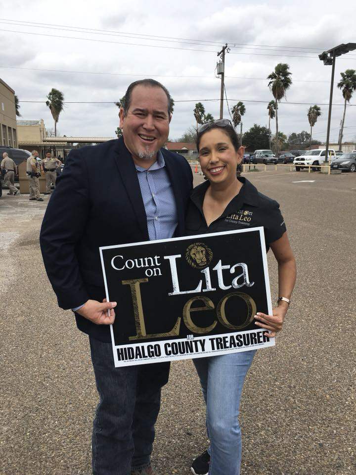 Two supporters displaying a Count on Lita Leo yard sign